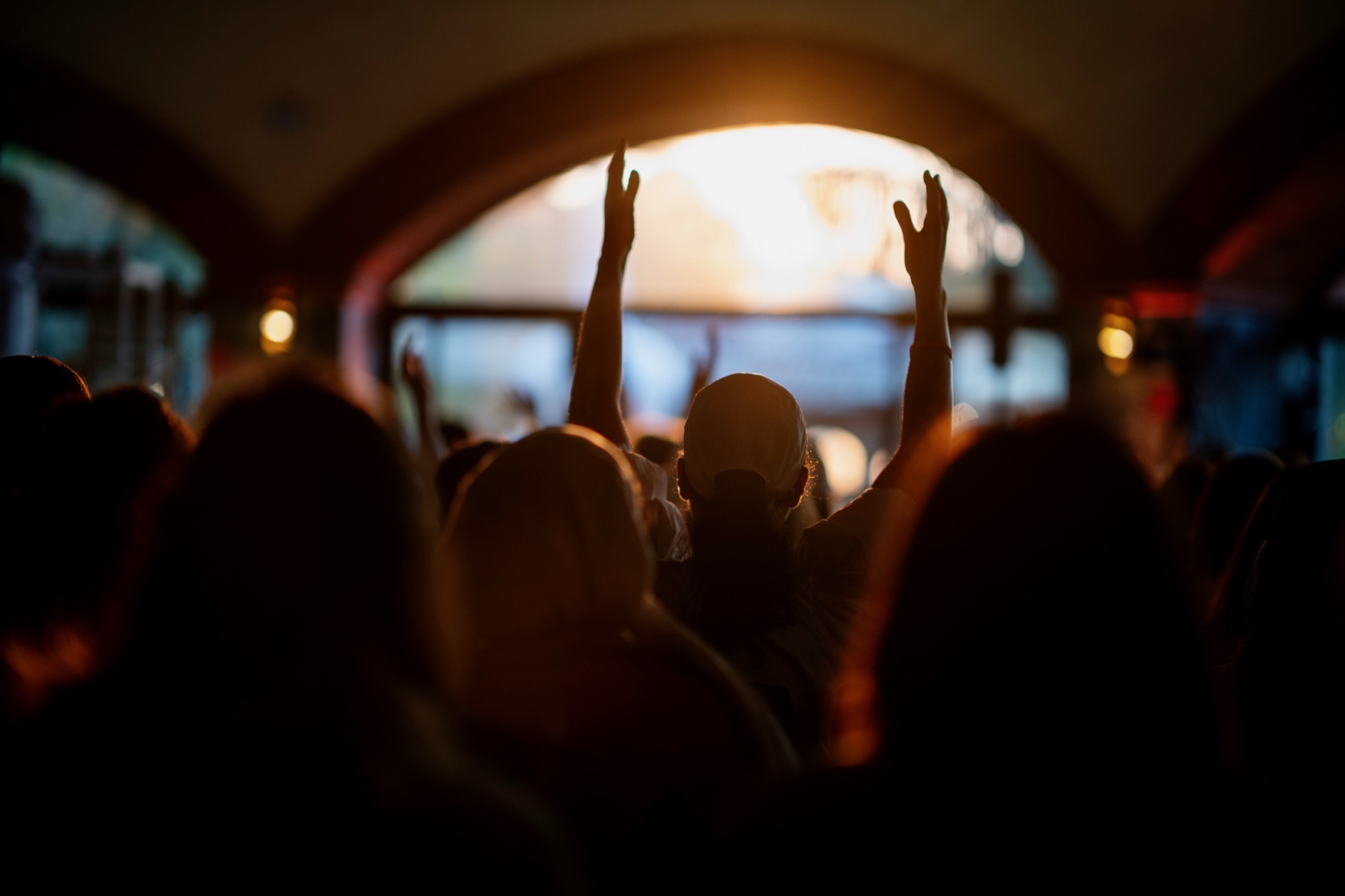 Hands raised at sunset at an Elevation gathering